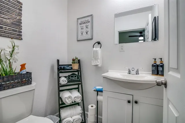 a bathroom with a sink toilet and mirror