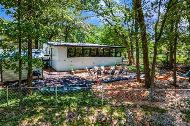 a view of a backyard with plants and a patio