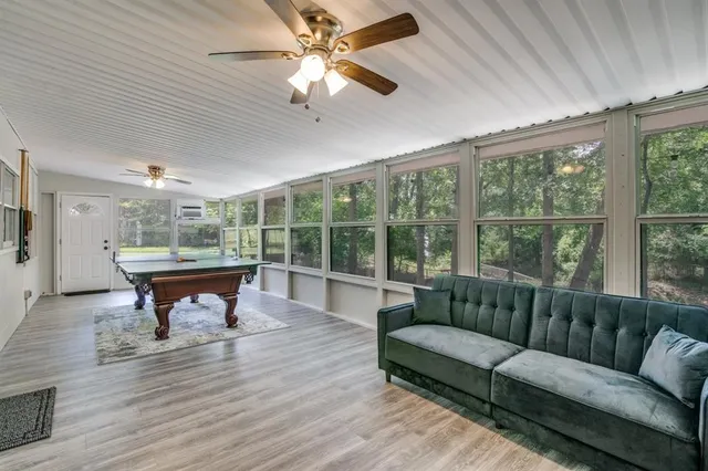 a living room with furniture a fireplace and a chandelier