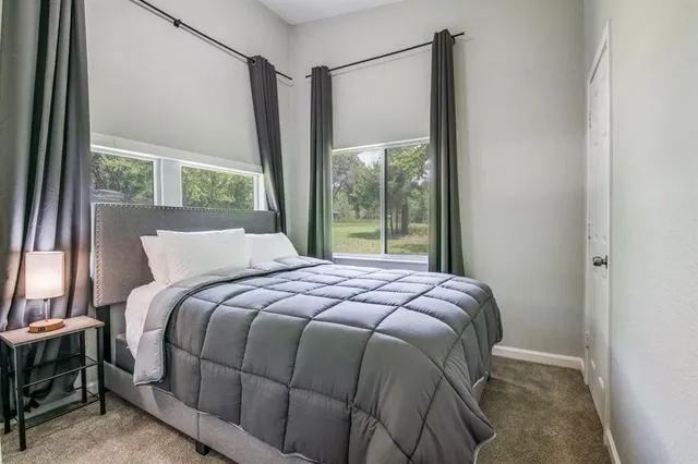 a bed sitting in a bedroom next to a window