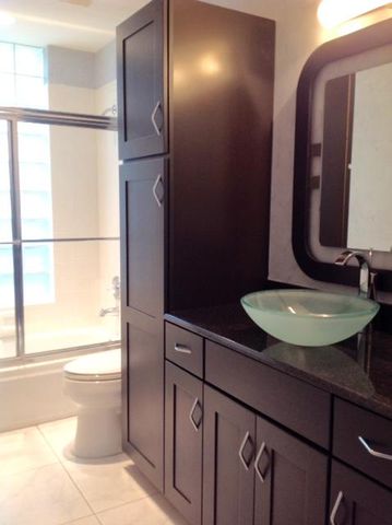 a view of an empty room with window and bathroom