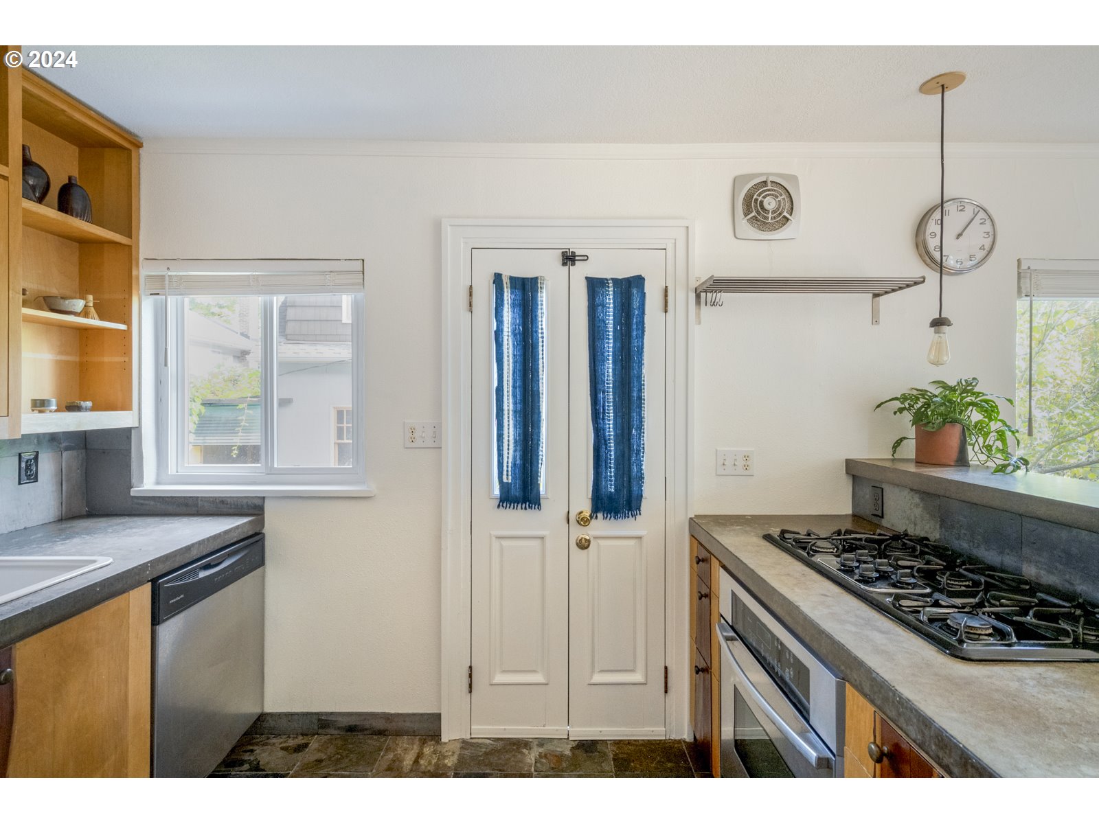 909 Northeast Brazee Street, Unit 17 Portland, OR 97212 - Photo 17 of 47 a kitchen with a stove and a wooden floors