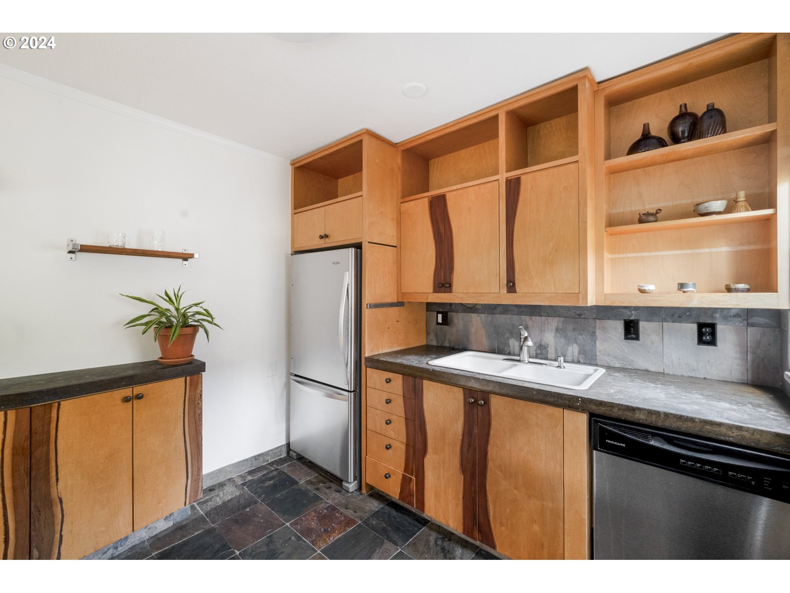 909 Northeast Brazee Street, Unit 17 Portland, OR 97212 - Photo 21 of 47 a kitchen with a sink a refrigerator and cabinets