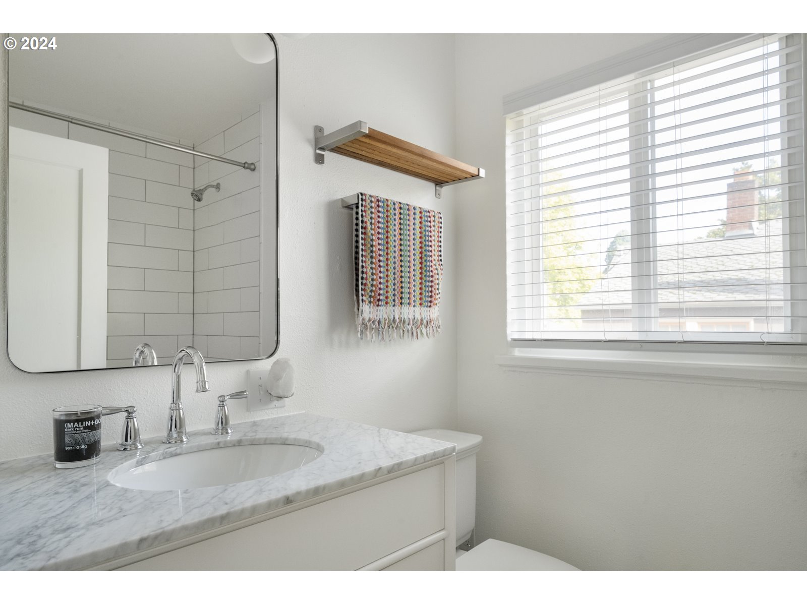909 Northeast Brazee Street, Unit 17 Portland, OR 97212 - Photo 32 of 47 a bathroom with a granite countertop sink and a mirror