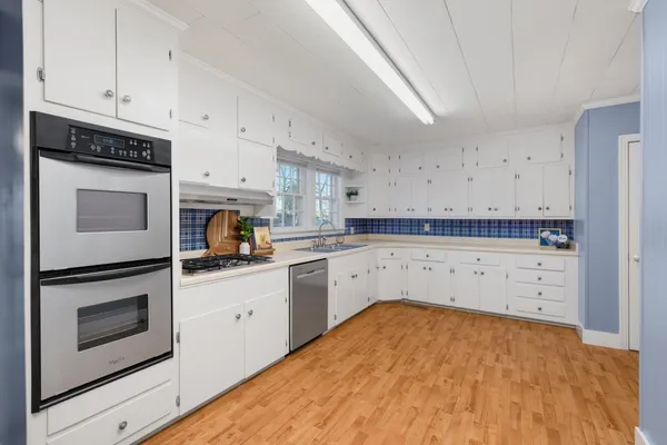 a kitchen with a sink stove and cabinets