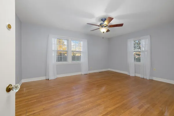 an empty room with a fireplace and cabinet