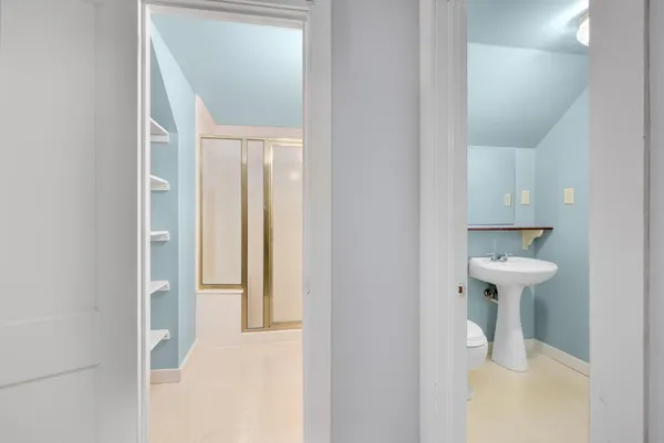 a bathroom with a sink a toilet and mirror