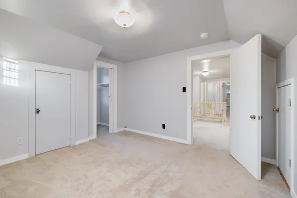 a view of a house with a big yard and large trees