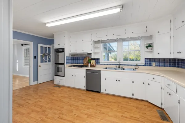 a kitchen with granite countertop a stove and a refrigerator