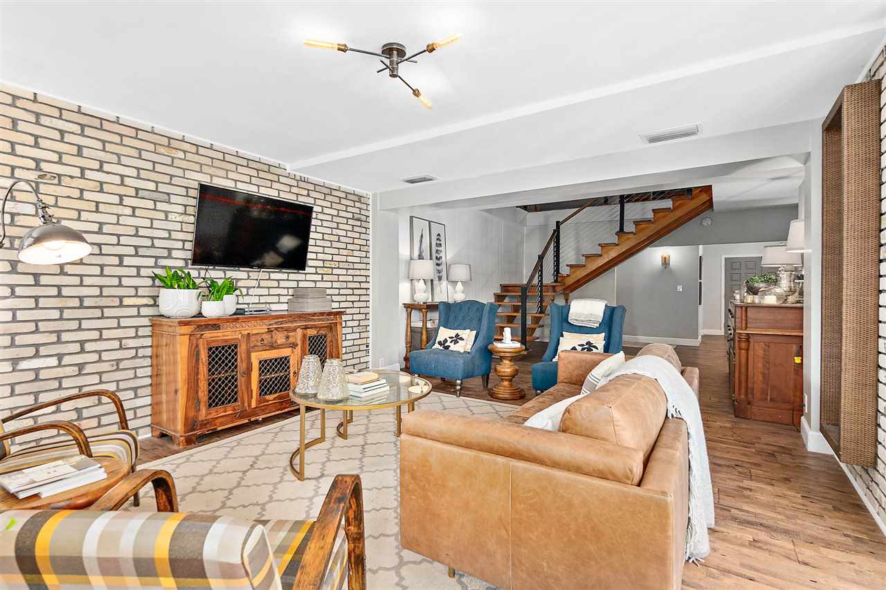 205 Oglethorpe Boulevard St. Augustine, FL 32080 - Photo 17 of 48 a living room with furniture a flat screen tv and a fireplace