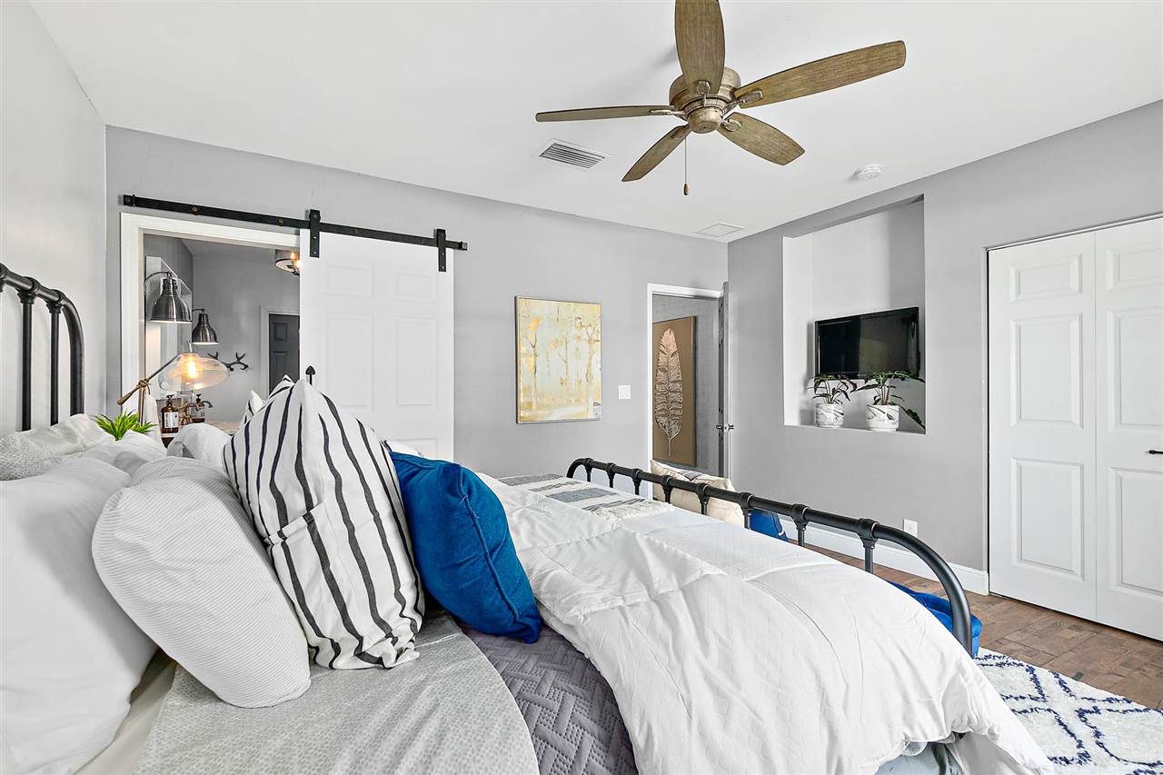 205 Oglethorpe Boulevard St. Augustine, FL 32080 - Photo 24 of 48 a bedroom with a bed and a flat tv screen