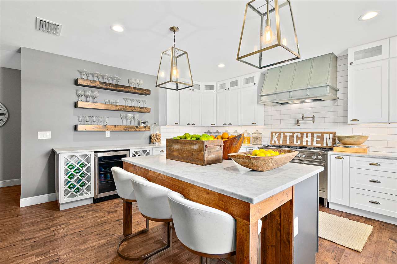205 Oglethorpe Boulevard St. Augustine, FL 32080 - Photo 3 of 48 a kitchen with stainless steel appliances granite countertop a sink a stove and a wooden floor