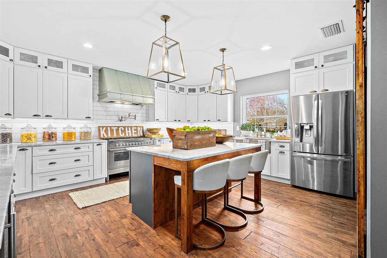 205 Oglethorpe Boulevard St. Augustine, FL 32080 - Photo 4 of 48 a kitchen with stainless steel appliances kitchen island granite countertop a table chairs stove and refrigerator