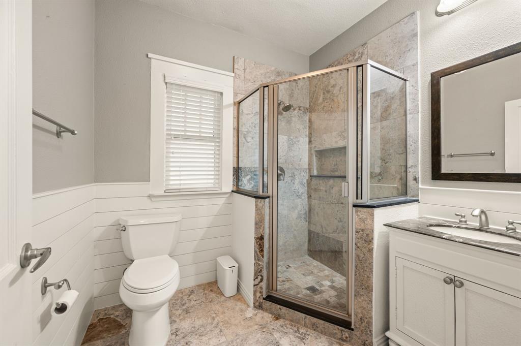 800 North Clements Street Gainesville, TX 76240 - Photo 19 of 27 a bathroom with a shower toilet and sink