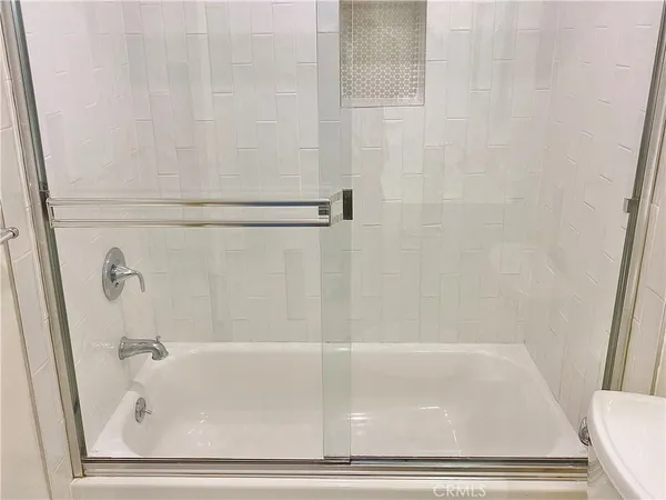 a view of backyard with seating space and wooden fence