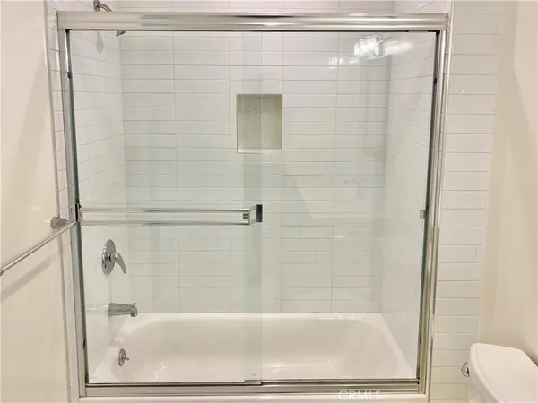 a view of a room with wooden floor and bench