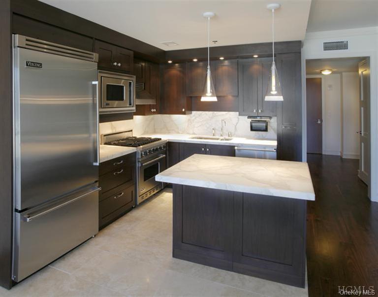 5 Renaissance Square, Unit 17C White Plains, NY 10601 - Photo 3 of 14 a spacious kitchen with a refrigerator and a sink