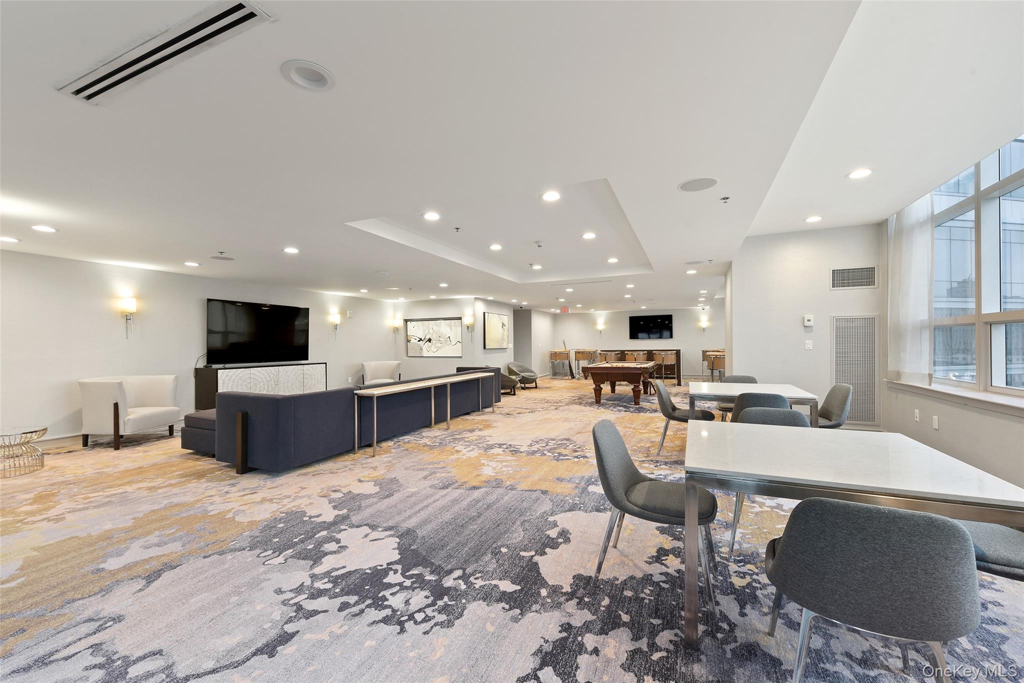 5 Renaissance Square, Unit 17C White Plains, NY 10601 - Photo 10 of 14 a living room with furniture and a flat screen tv