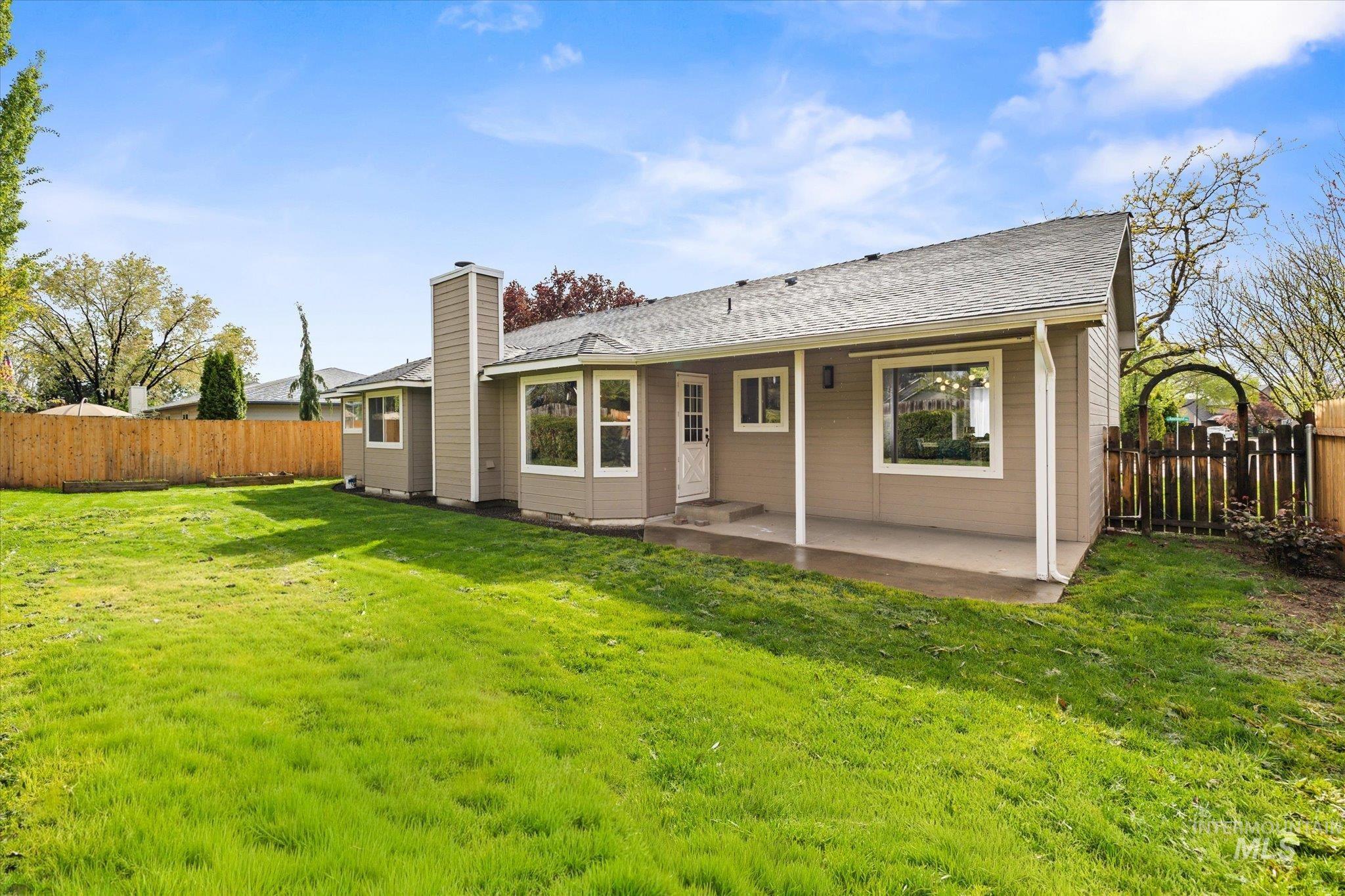 2250 North Amethyst Avenue Meridian, ID 83646 - Photo 45 of 50 Back of house featuring a patio, a fenced backyard, a chimney, and roof with shingles
