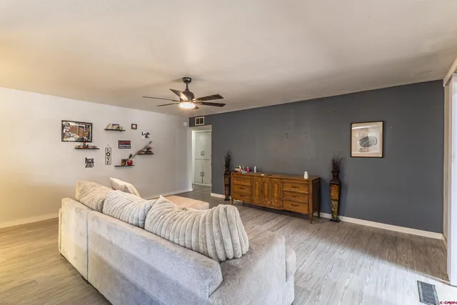 a bedroom with furniture and a wooden floor