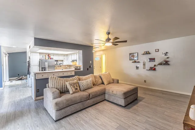 a living room with furniture and wooden floor