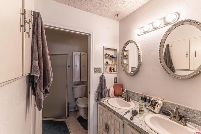 a bathroom with a double vanity sink and a mirror