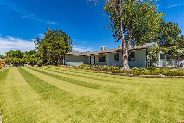 a house view with swimming pool in front of it