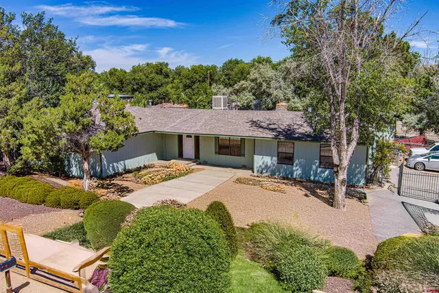 a front view of a house with yard and seating area
