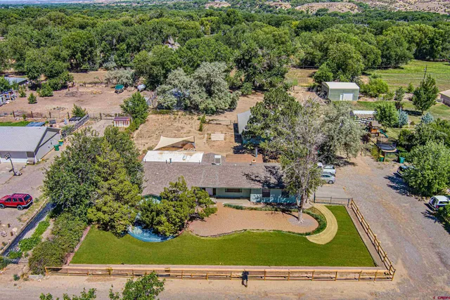 an aerial view of a house with yard swimming pool and outdoor seating
