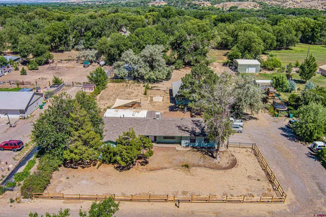 an aerial view of a house with a yard basket ball court and outdoor seating