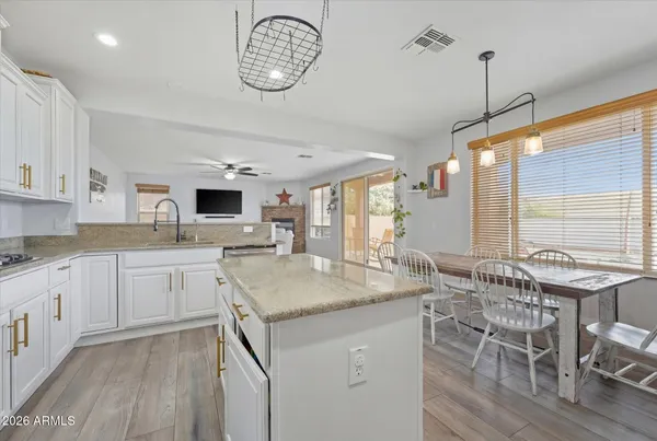 a kitchen with a table chairs stove and cabinets