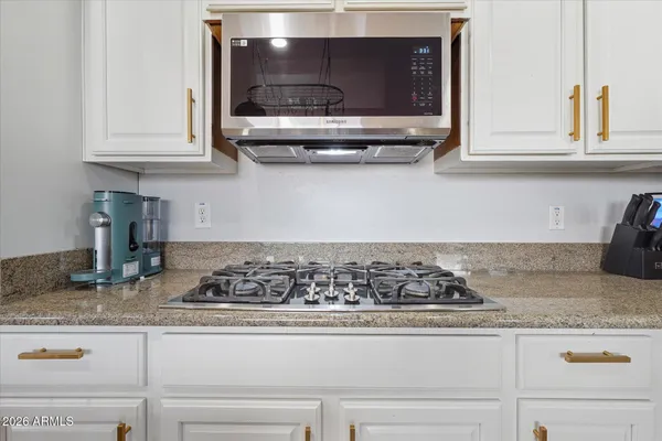 a kitchen with granite countertop cabinets and stainless steel appliances