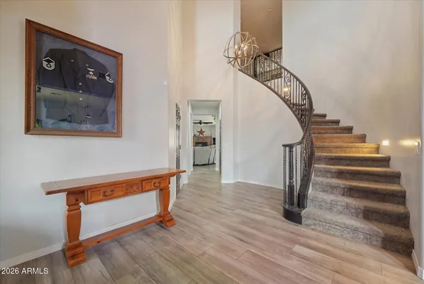 a view of entryway and hall with wooden floor