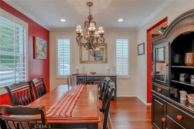 a view of a dining room with furniture wooden floor and chandelier