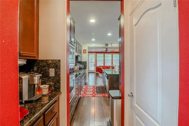 a kitchen with stainless steel appliances granite countertop a refrigerator and a stove