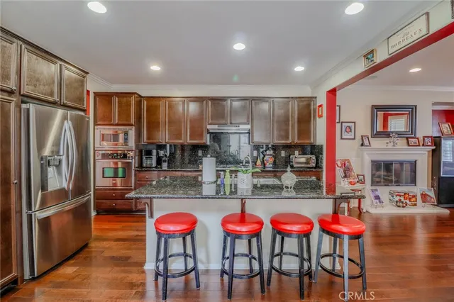 a kitchen that has a table chairs and wooden floor