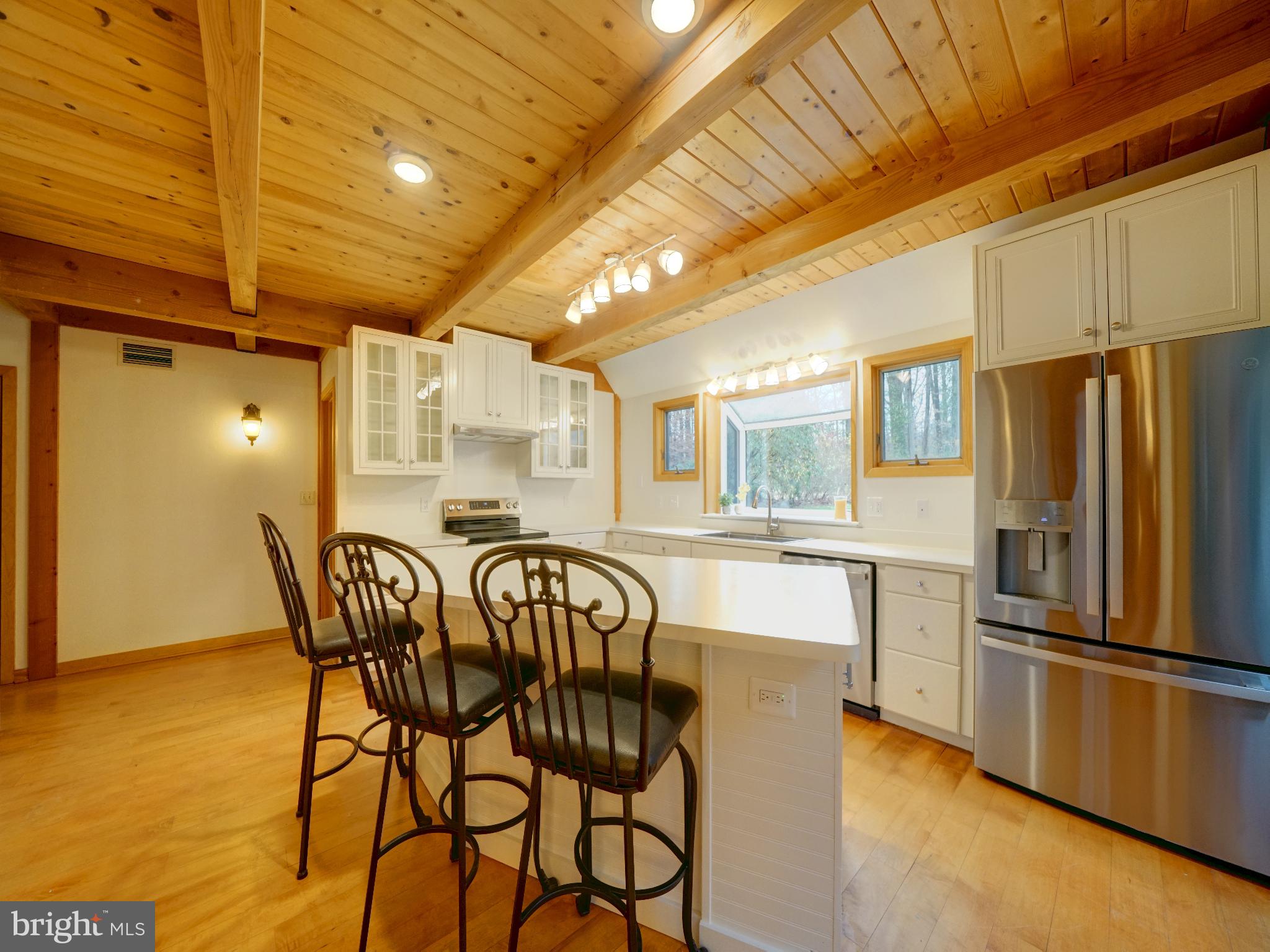 11818 Linden Chapel Road Clarksville, MD 21029 - Photo 11 of 121 a kitchen with stainless steel appliances a refrigerator a stove a sink dishwasher with a dining table and chair