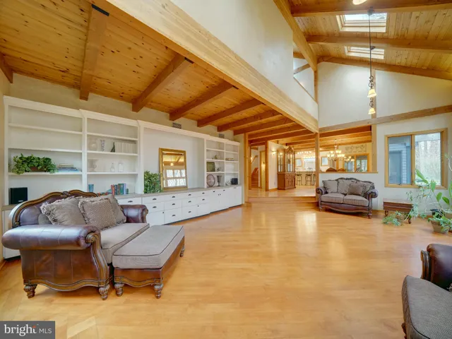 a kitchen with stainless steel appliances a refrigerator a stove a sink dishwasher with a dining table and chair