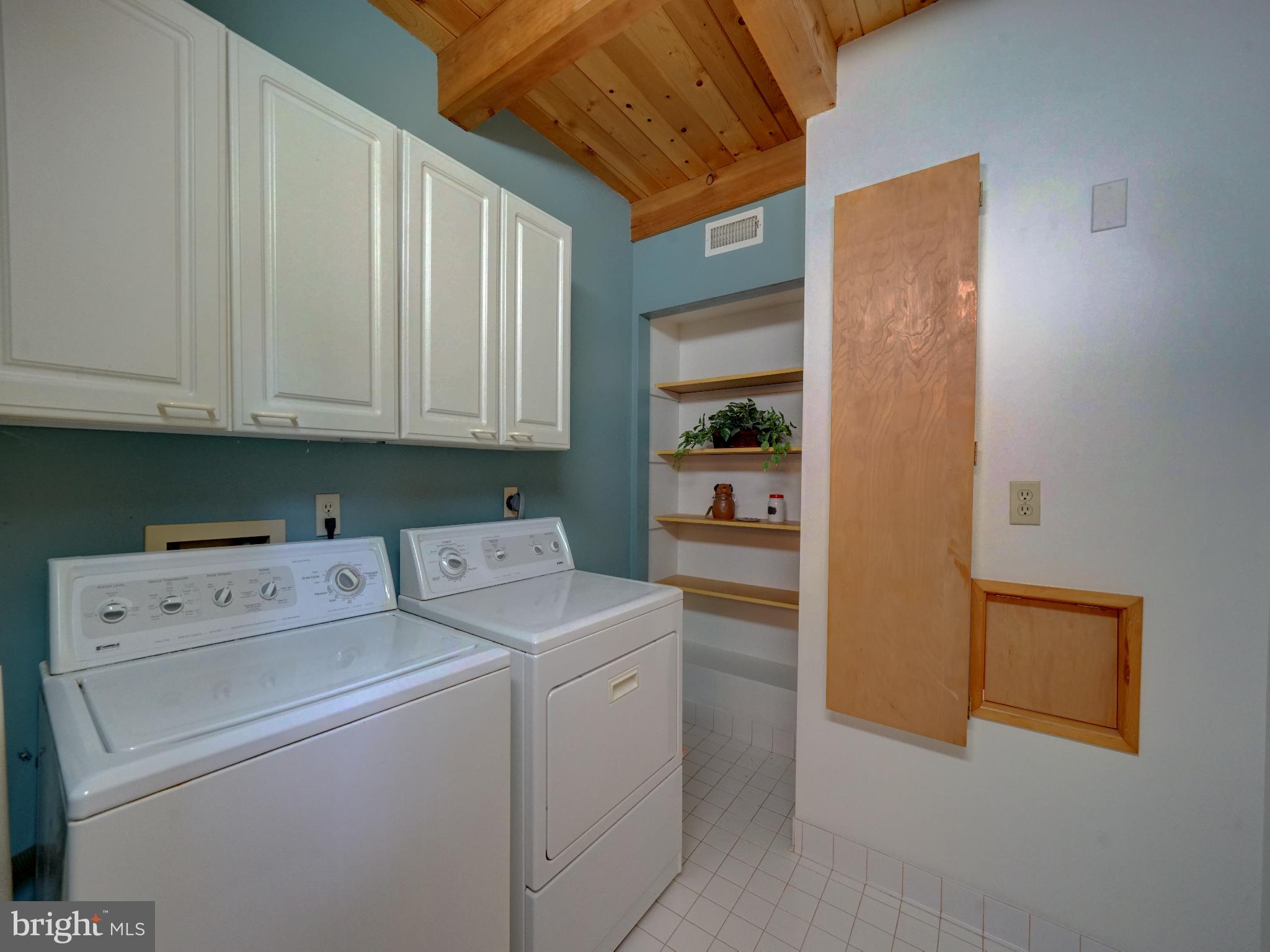 11818 Linden Chapel Road Clarksville, MD 21029 - Photo 62 of 121 a view of washer and dryer with kitchen in the background