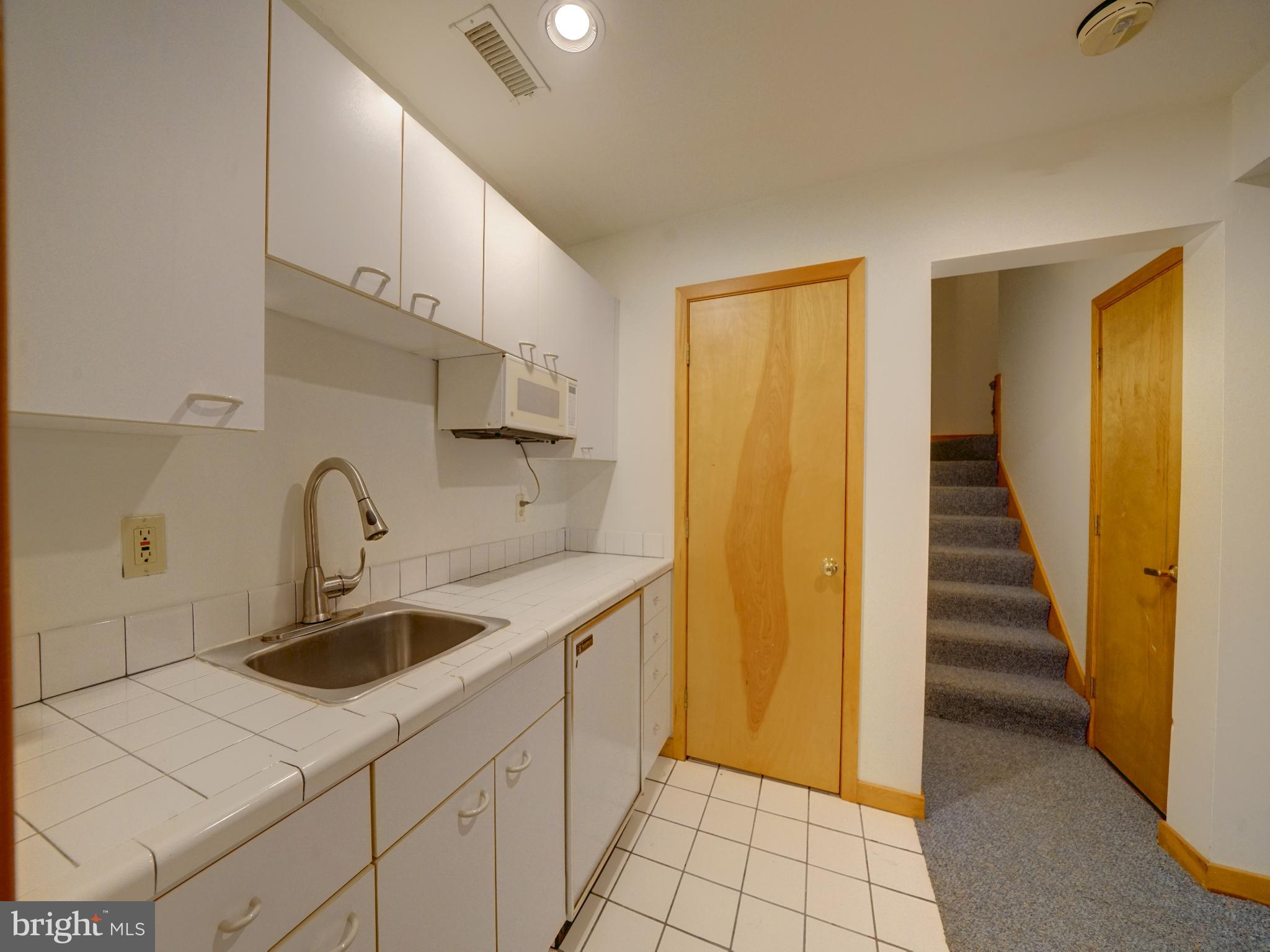 11818 Linden Chapel Road Clarksville, MD 21029 - Photo 82 of 121 a kitchen with sink cabinets and entryway