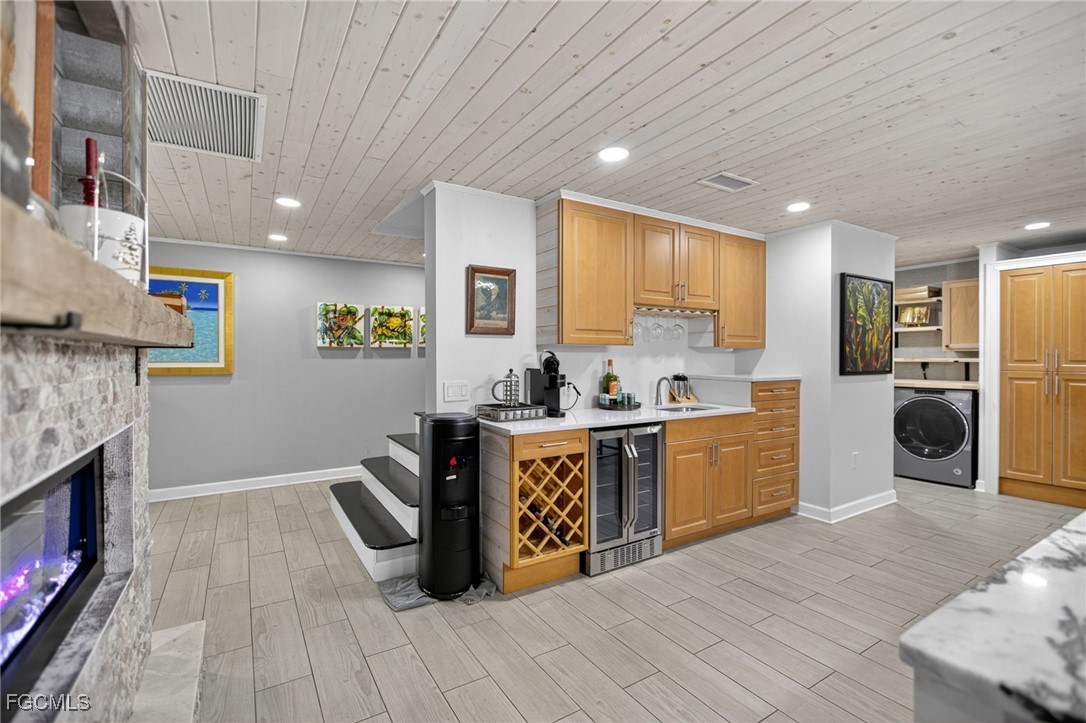 1549 Braeburn Road Fort Myers, FL 33919 - Photo 16 of 38 a large kitchen with stainless steel appliances granite countertop a stove a sink dishwasher and a refrigerator with wooden floor