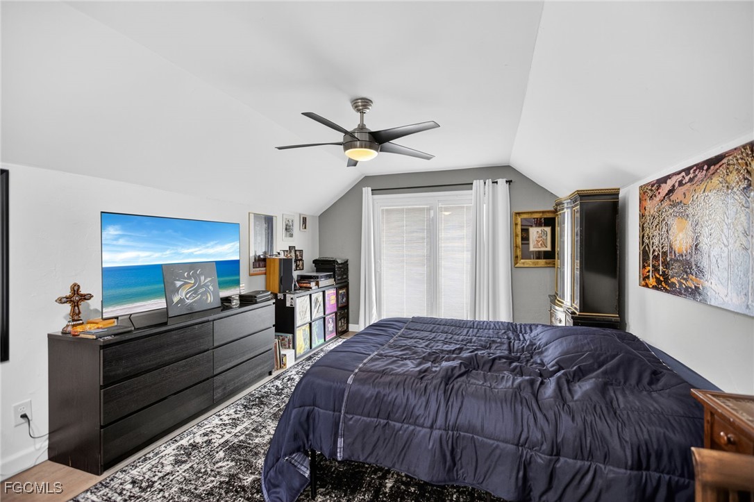 1549 Braeburn Road Fort Myers, FL 33919 - Photo 28 of 38 a bedroom with a bed and ceiling fan