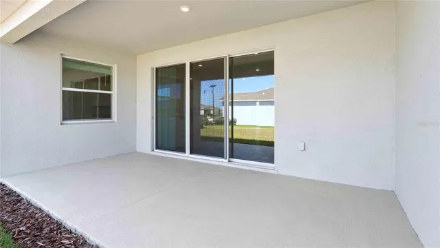 an empty room with windows and entrance