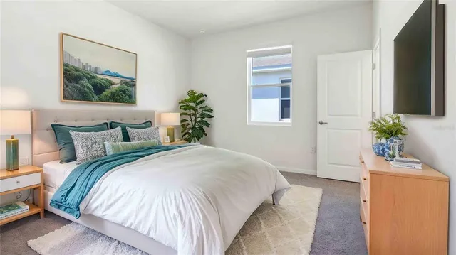 a bedroom with bed and a window