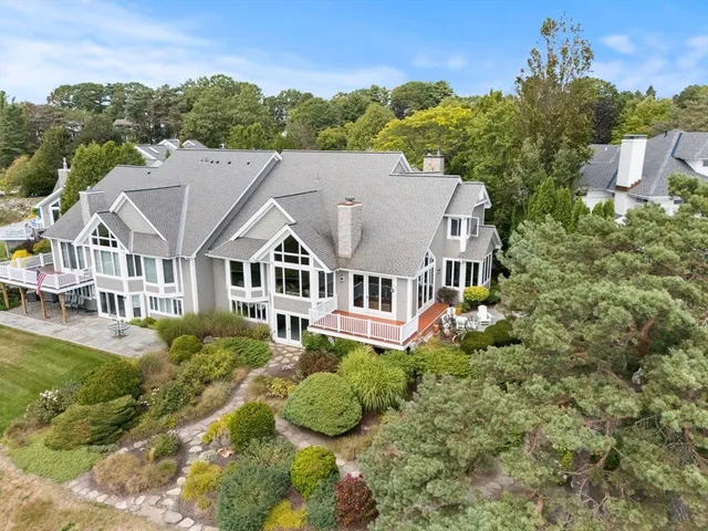 a aerial view of a house with a big yard and potted plants