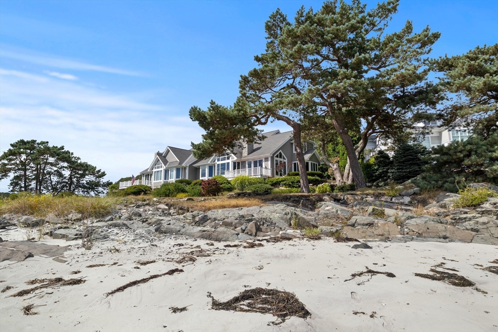 163 Little Harbor Road, Unit 163 New Castle, NH 03854 - Photo 12 of 36 a front view of a house with a yard