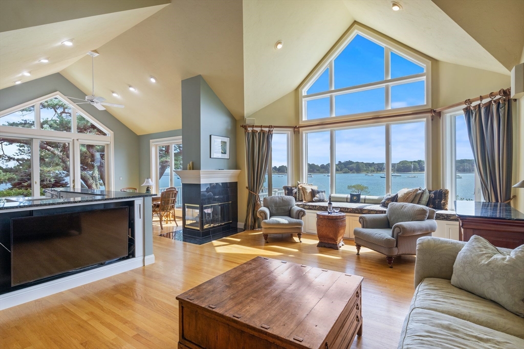 163 Little Harbor Road, Unit 163 New Castle, NH 03854 - Photo 17 of 36 a living room with furniture fireplace and large window