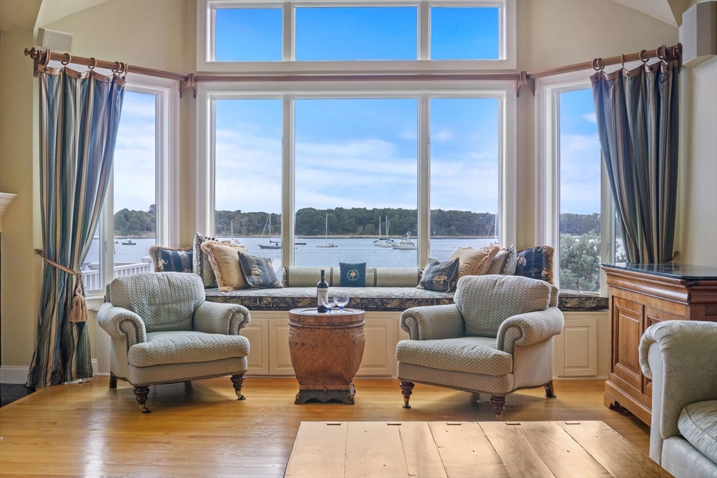 163 Little Harbor Road, Unit 163 New Castle, NH 03854 - Photo 18 of 36 a living room with furniture large windows and a rug