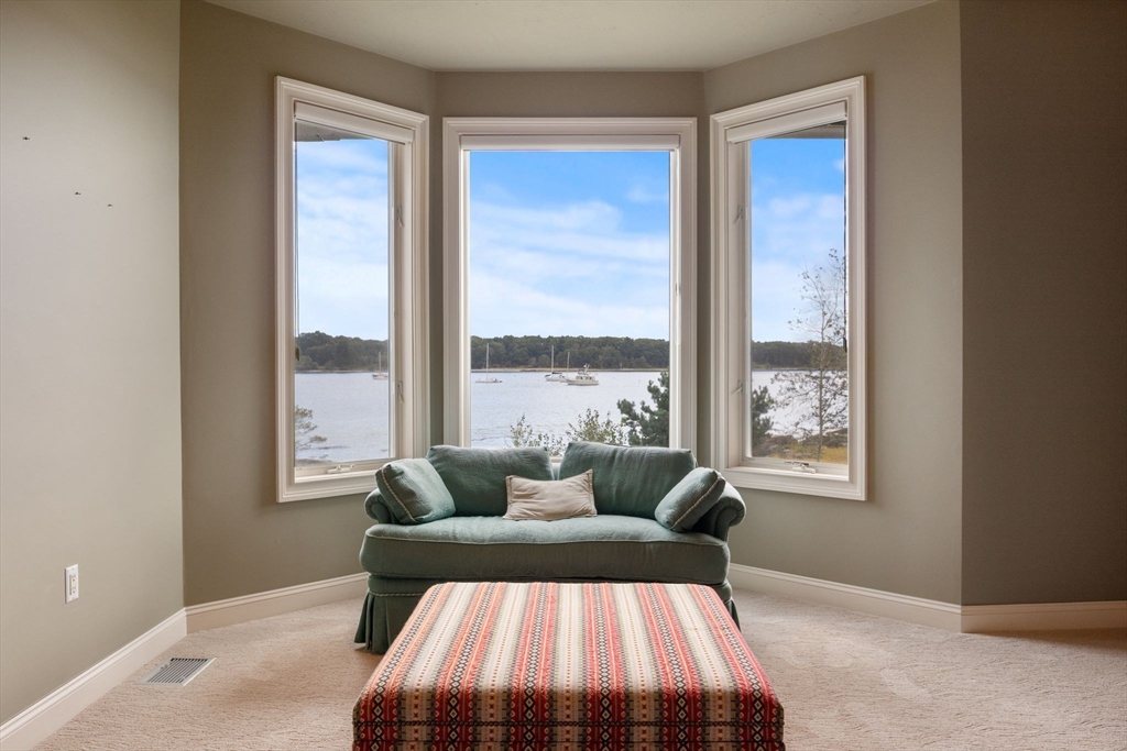 163 Little Harbor Road, Unit 163 New Castle, NH 03854 - Photo 25 of 36 a bedroom with furniture and windows