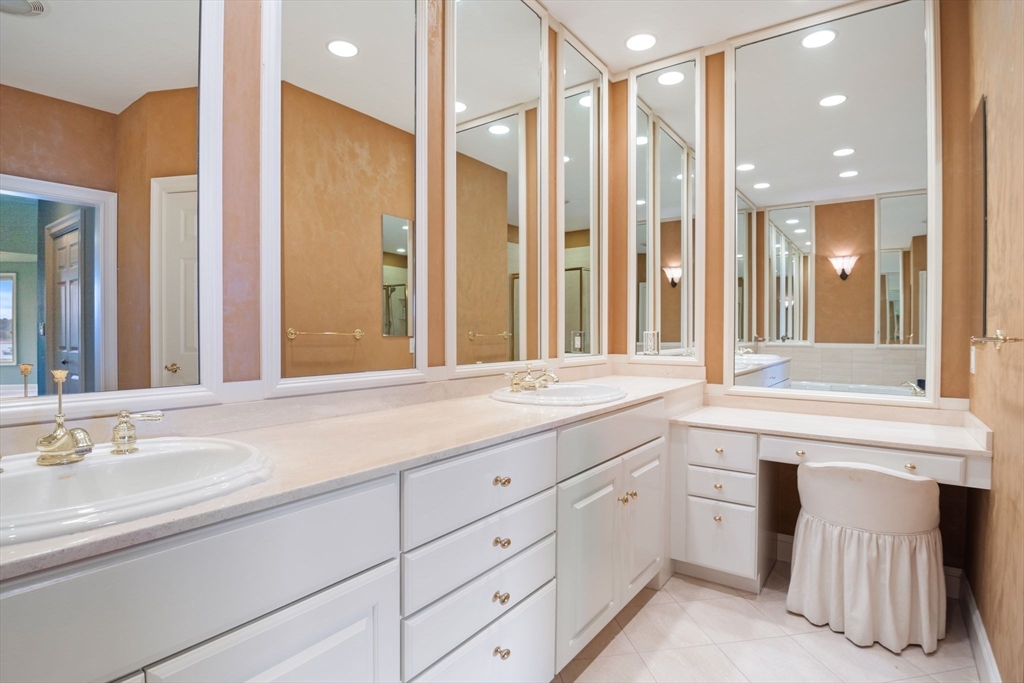 163 Little Harbor Road, Unit 163 New Castle, NH 03854 - Photo 27 of 36 a bathroom with a granite countertop sink and a mirror